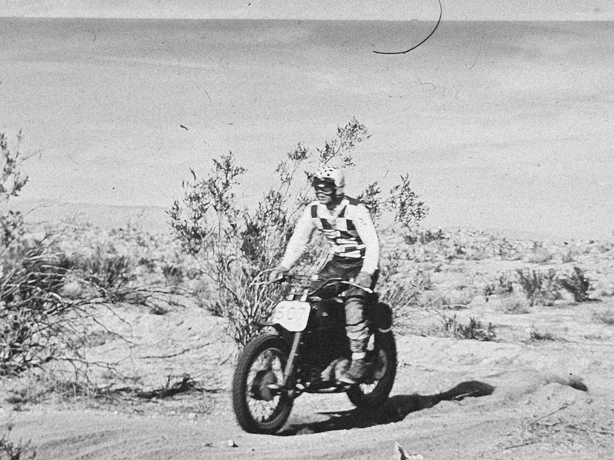 Vintage motorcycle rider crossing the desert.